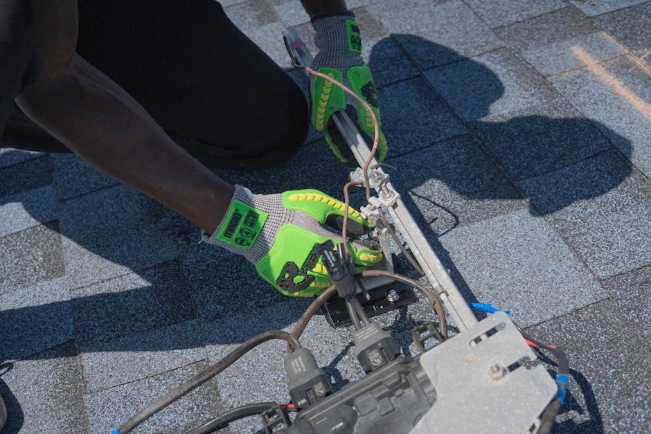 Electrician safely connecting the wiring for a new solar power system.